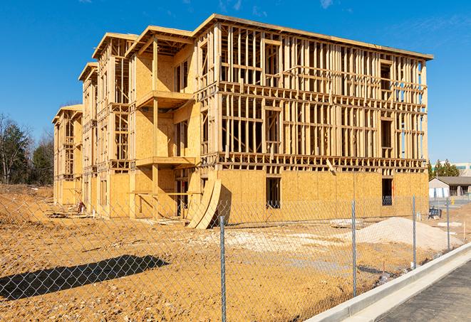 construction zone secured with a temporary fence, marked with warning signs in West Valley City